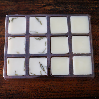 Square wax melts in a mold on a wooden surface