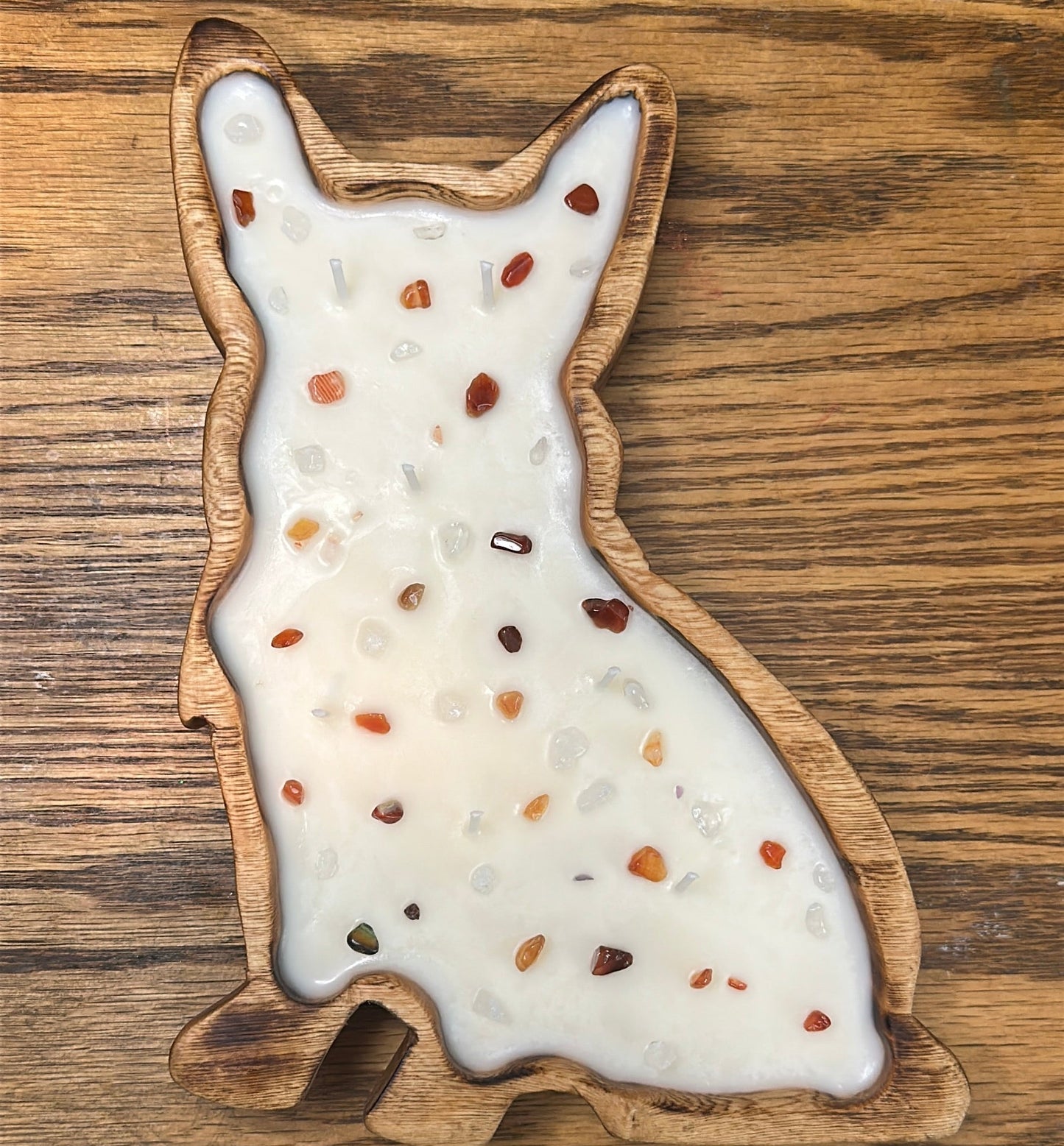 A Corgi-shaped wood candle with gemstones